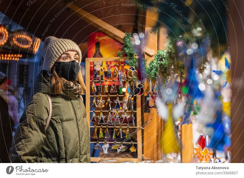 Woman in face mask on Christmas shopping woman christmas market protection lifestyle holiday coronavirus celebration winter tallinn estonia city season portrait