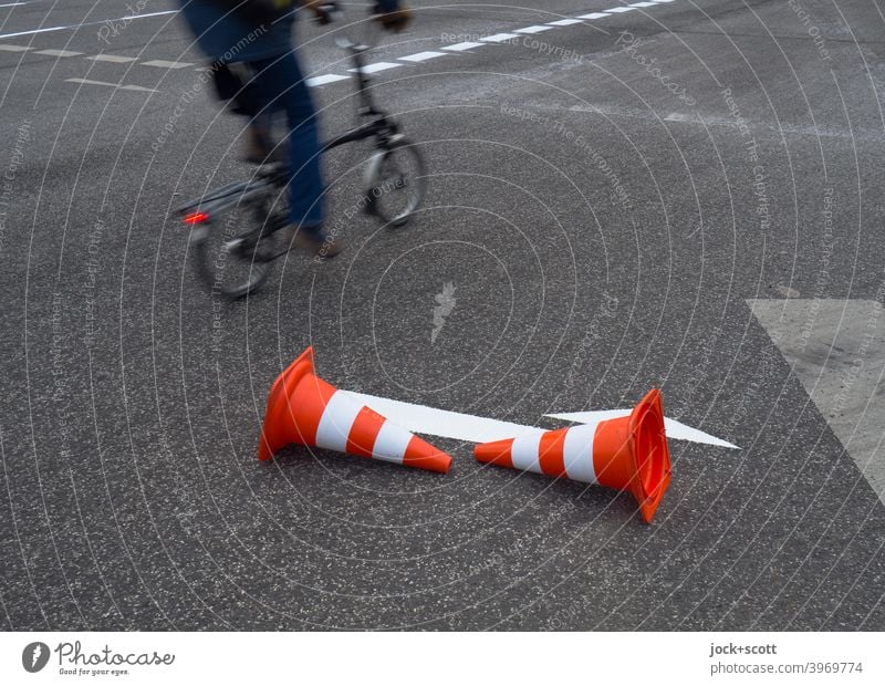 Guide cone directs cyclists around the freshly painted white arrow guiding cone Lane markings Arrow Traffic infrastructure Asphalt Street Direction Road sign