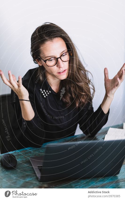 Stressed woman working on laptop at home remote using online freelance young female formal lifestyle device gadget browsing internet connection communicate