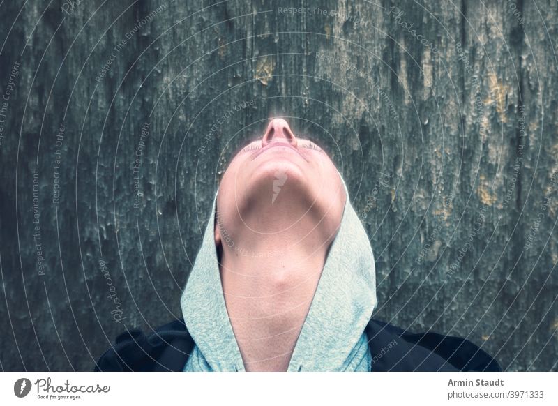 vision, portrait of a young man with closed eyes who looks up motion blur above head neck nose back look up hoodie wall speed teenager looking male beautiful