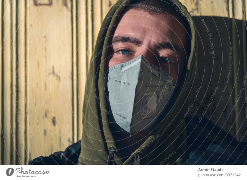 portrait of a young man with a FFP3 corona mask ffp3 protection pandemic pollution virus health care disease infection protective corona virus toxic caucasian