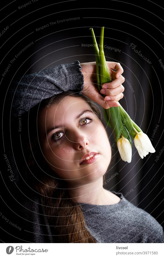 romantic teenager with tulips girl model young flower yellow tulips confined black and white at home pretty beauty real people sad attitude interior hand indoor
