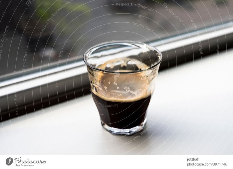 A glass of espresso stands on a windowsill Espresso Coffee Beverage Hot drink Morning in the morning Wake up Caffeine Ritual Break Alert tired Fatigue Fluid