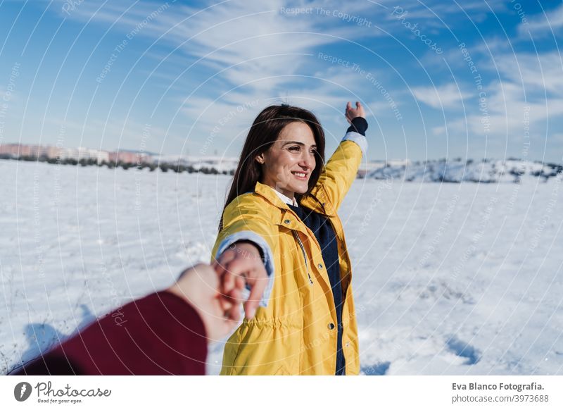 happy young woman holding hands with camera. snow mountain landscape. Follow me. Love and lifestyle in nature boyfriend love valentines snowy romantic scene