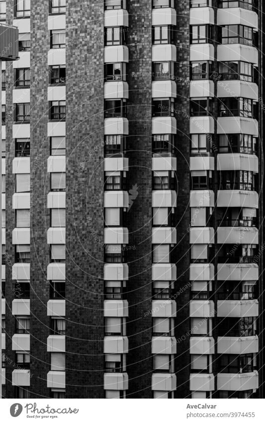 A close up of a repetitive building on black and white with copy space and cinematic ambient rise property estate future residential tech renewal lines symmetry