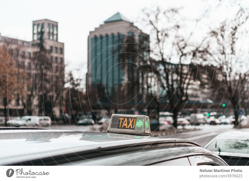 Closeup shot of a taxi sign on a car. contemporary inscription travel waiting journey service traffic day city life text symbol transport transportation word