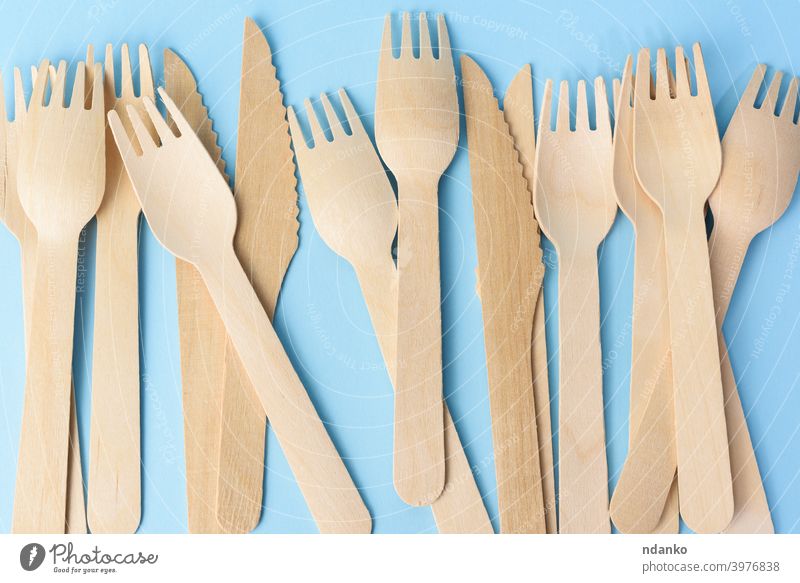 wooden forks and knives on a blue background knife eco white cutlery food object utensil disposable set equipment meal simple dining kitchen tool tableware