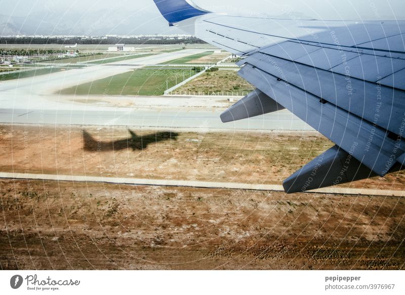 Off on holiday, shadow of a plane taking off Airplane View from the airplane Airplane takeoff take off Aviation Colour photo Exterior shot Passenger plane