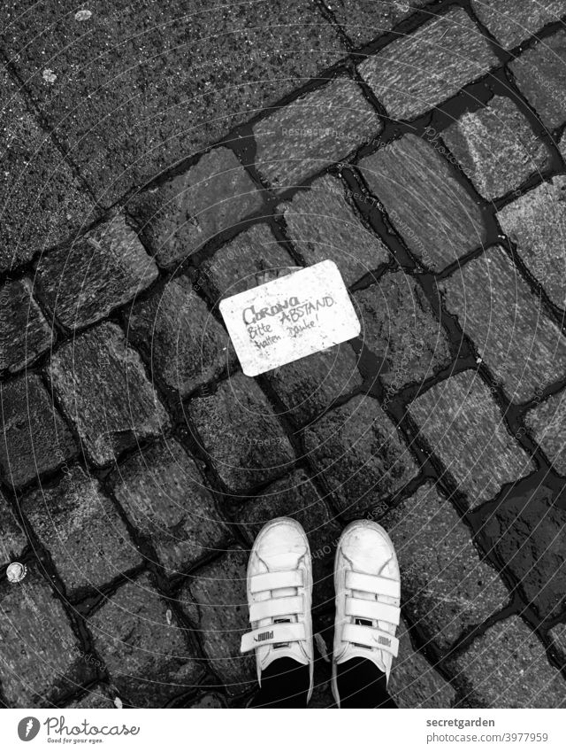 Please keep your distance. Thank you. feet sneakers Black & white photo Rich in contrast Contrast Paving stone Lanes & trails Signs and labeling Corona virus