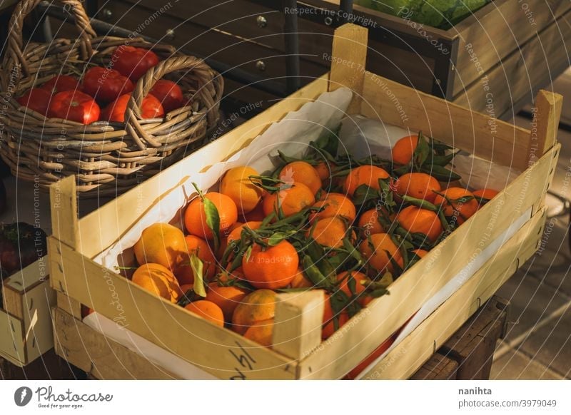 Self service fruit store with many organic products stall vegetables market delicious variety tomatoes clementines citrus fruits wood wooden basket harvest