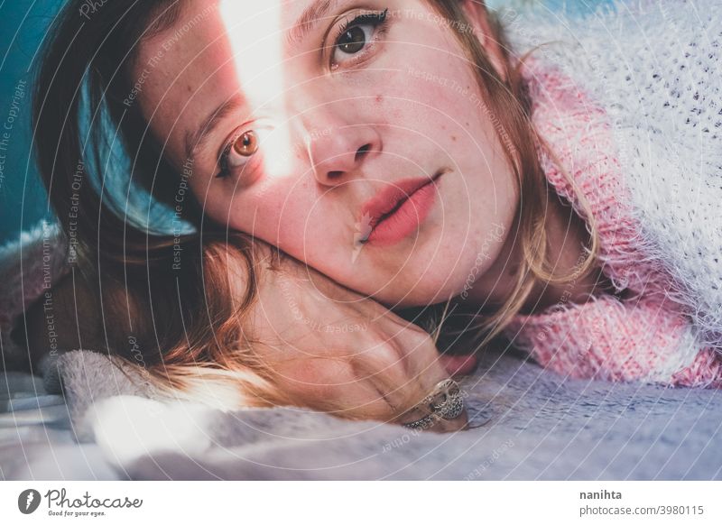 Portrait of a young woman with her face crossed by a sun shine light beauty pretty artistic portrait shadow natural sunny shadow play blonde youth fresh hope