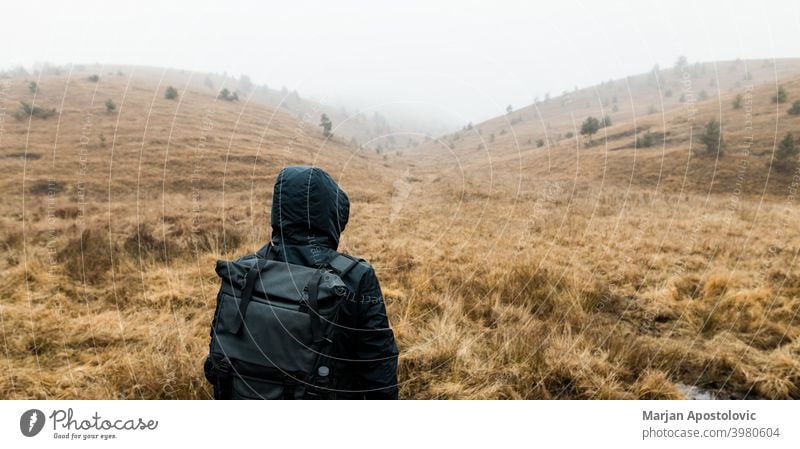 Young man exploring nature on a wet winter morning in the mountains adventure alone autumn beautiful challenge cold europe exploration explore explorer fog