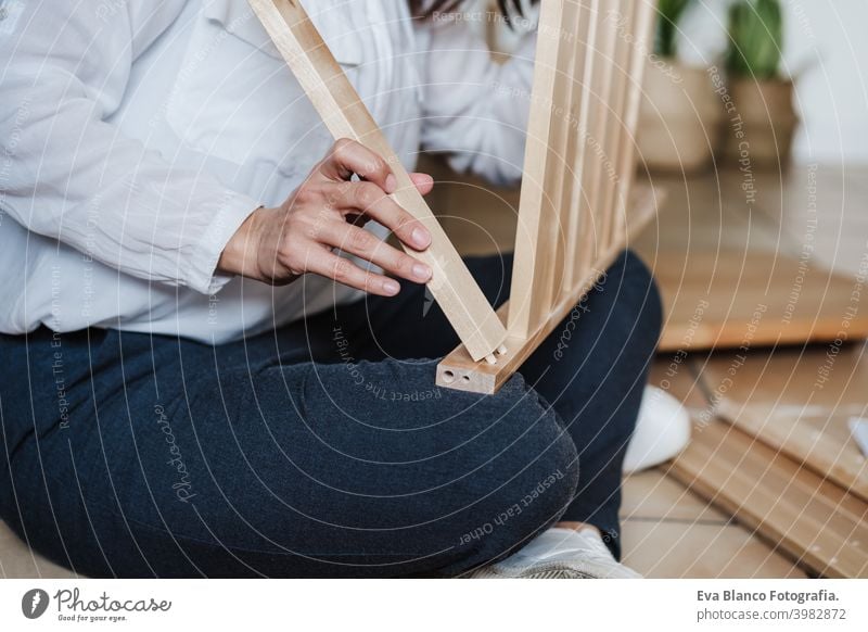 close up of young woman assembling furnitures. DIY concept do it yourself home house caucasian indoor working renovation young adult craft bricolage skill