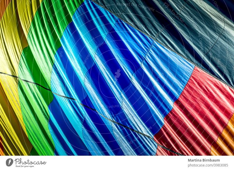 Colorful outside of a deflating hot air balloon rainbow circle colors center centered symmetry fabric hotair fun colorful ballooning background fly