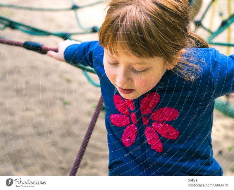 Little redhead girl playing on playground summer fun child smiling childhood cute cheerful little playful happy park happiness joy activity active leisure
