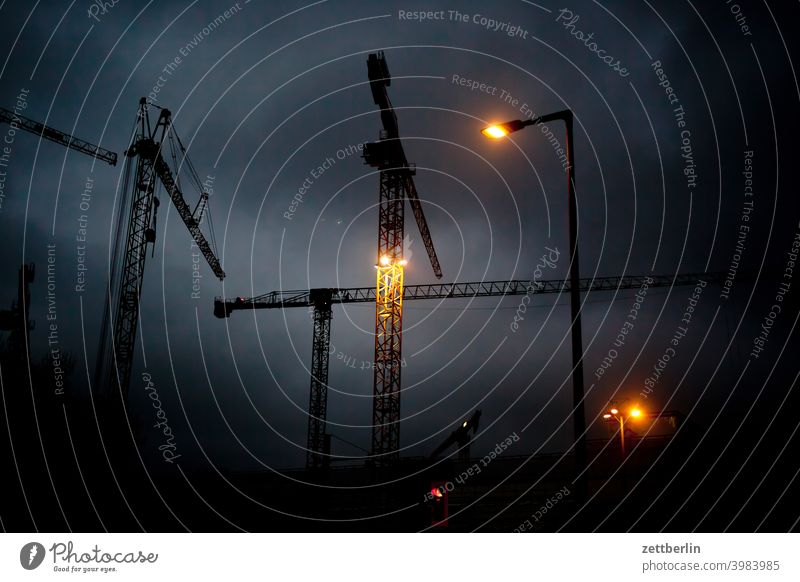 Construction site in the evening Structural engineering Evening Architecture construction industry Berlin Office city Germany slewing crane Twilight