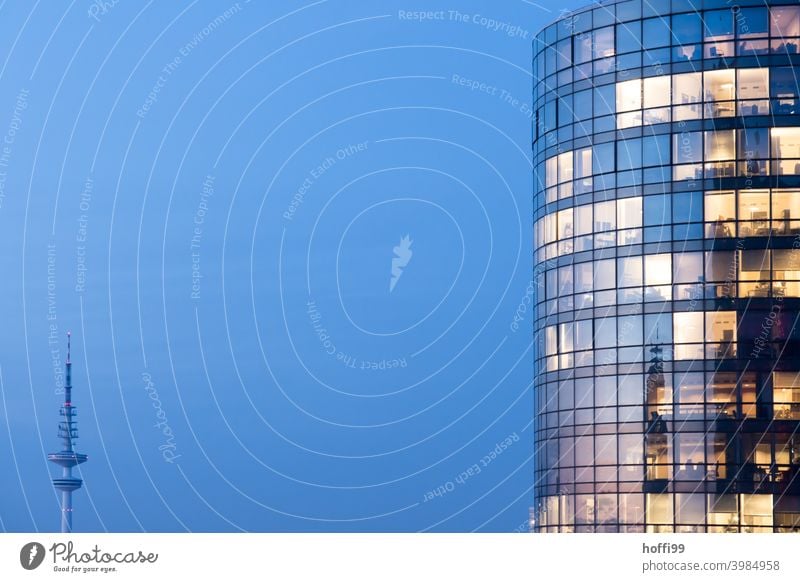 Radio tower and office building at the blue hour Television tower Office building Glas facade Glass panes Lighting Blue sky deep blue Architecture High-rise