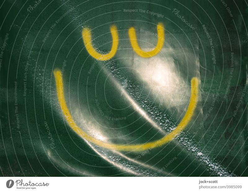 yellow smiley sprayed on wavy greenish plastic tarp tarpaulin Green reflection Snowflake Structures and shapes Simple Plastic Street art Smiley Detail