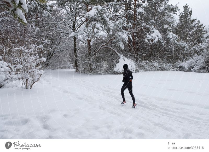 A man jogs through the snow in winter Snow Jogging Walking Sports Winter Man Fitness Movement Athletic Park Nature Snowscape Runner workout Jogger