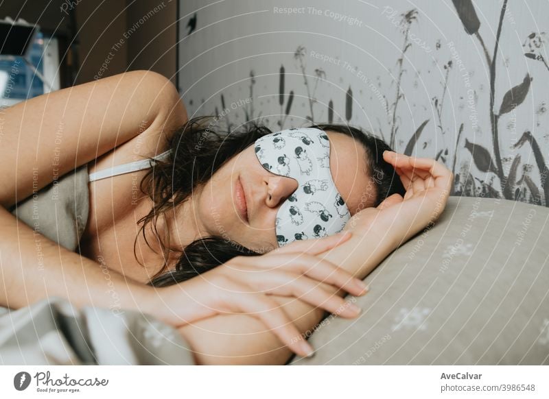 A young woman sleeping on the bed with a white sleeping mask dream peace wellness youth asleep good smile blindfold expression balance lipstick person room