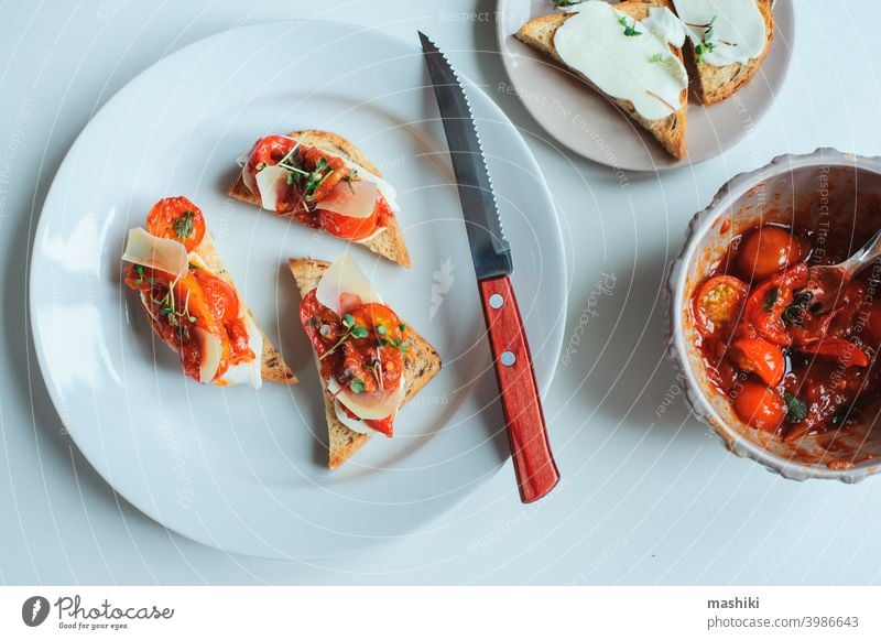 delicious italian appetizer - crostini toast with baked cherry tomatoes, farm cheese and provence herbs sandwich bread food bruschetta fresh meal snack