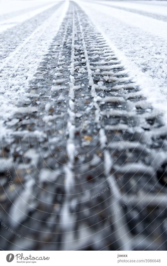 Long track of a tire tread in the new snow on the road tyre track trace Profile Snow track Imprint Tire Street Winter Track width Ice Perspective Skid marks