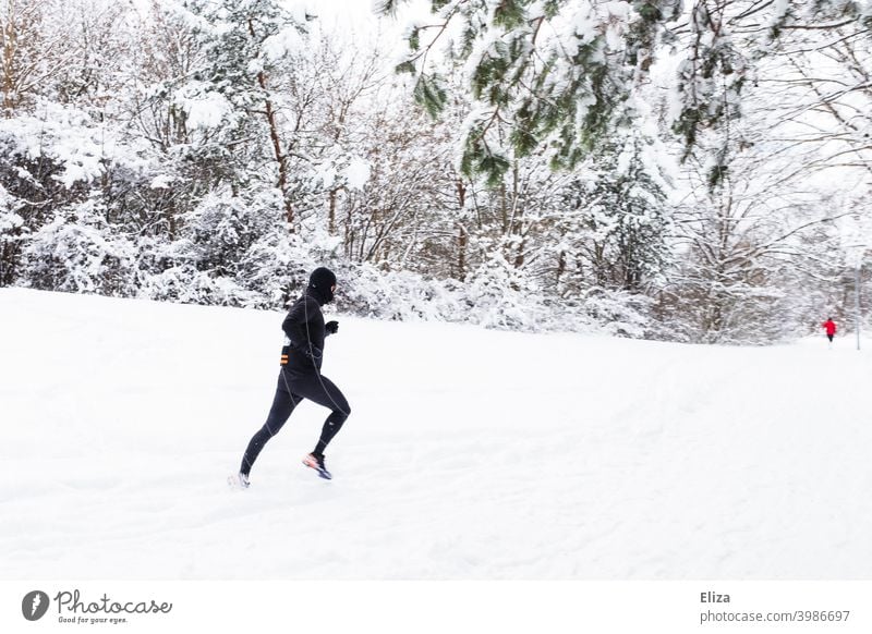 A man jogs through the snow in winter Snow Jogging Walking Sports Winter Man Fitness Movement Athletic Park Nature Snowscape Runner workout Jogger