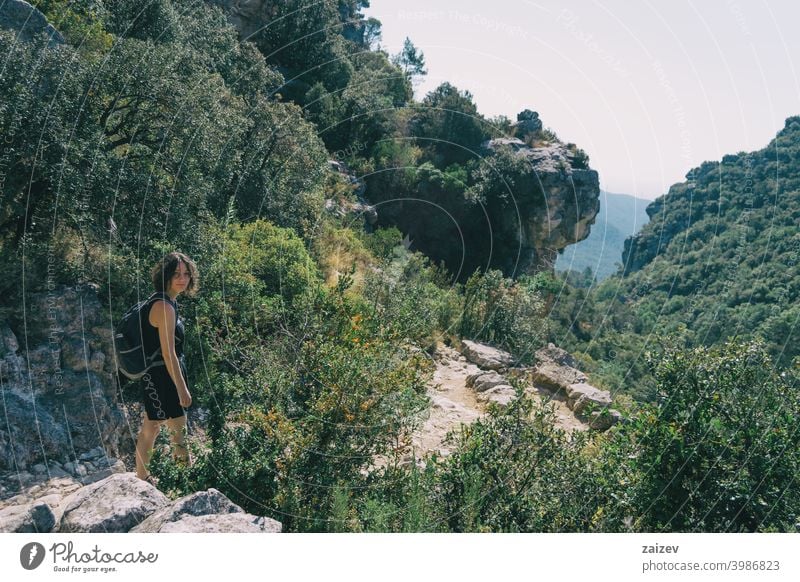 Girl walking along a small path in the mountain of Prades, Tarragona, Spain. prades catalonia spain la febró outdoor medium copy space color people female