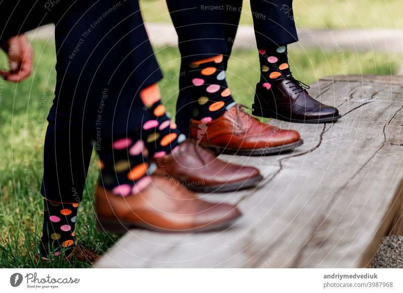 stylish men's socks. Stylish suitcase, men's legs, multicolored socks and new shoes. Concept of style, fashion, beauty and vacation concept background people