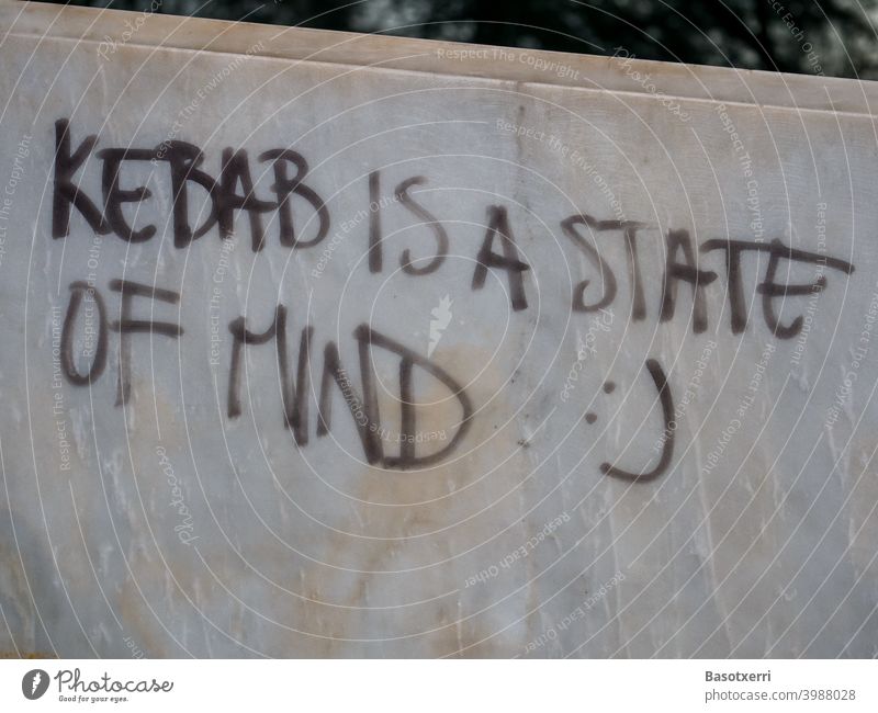 Graffiti "Kebab is a State of Mind" on a polished marble wall Lifestyle Eating food Philosophy Fast food Nutrition Marble Wall (building) house wall Park