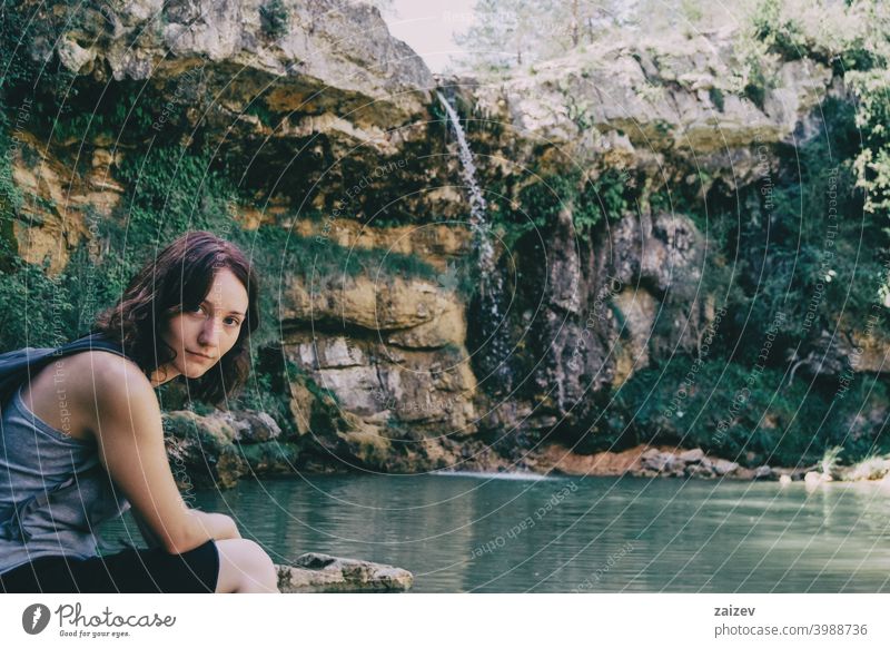 woman next to a waterfall peaceful human perfect pure relaxing skin person enjoying paradise alternative happiness one person lady quiet young jungle bikini
