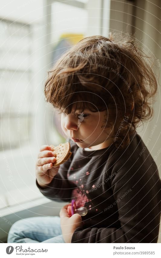 Cute little girl eating cookie Child childhood Cookie Eating thinking Colour photo Infancy Human being kid Delicious Joy Authentic Caucasian Calm