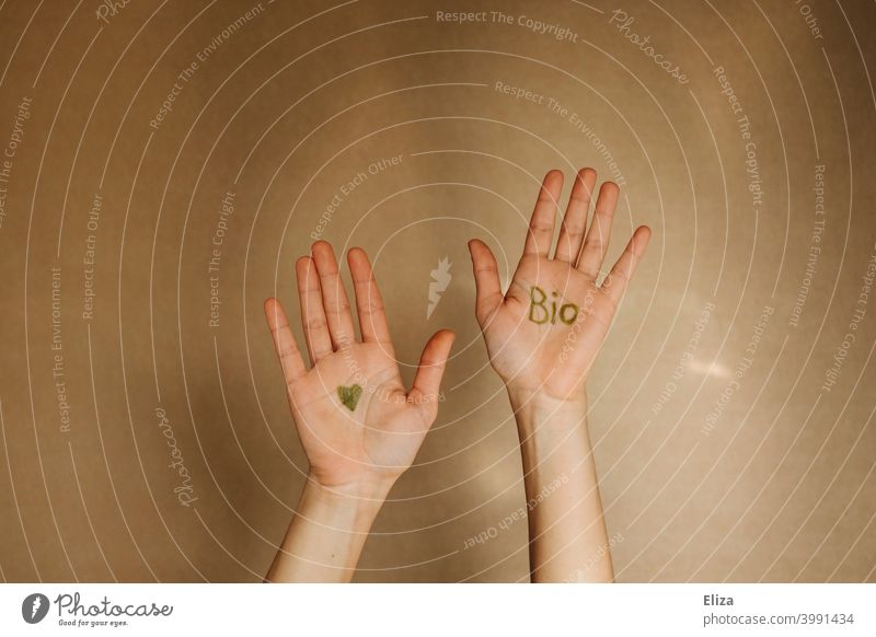 Hands with the word bio and a heart in green color organic Ecological Organic produce hands Sustainability salubriously Heart Nutrition Eco-friendly Biological