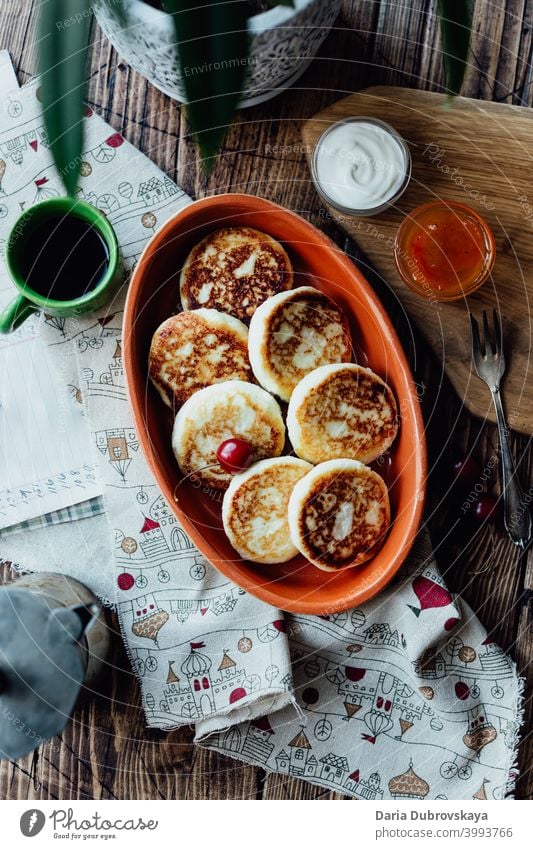 cottage cheese pancakes on a wooden table sweet breakfast dish dessert traditional plate curd dairy roasted meal morning fried food cuisine homemade rustic
