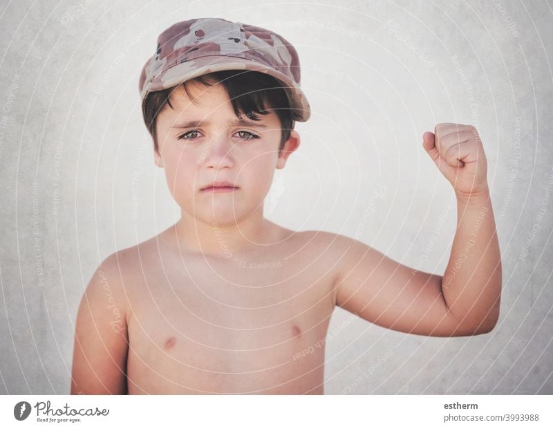 Sad child with his fist closed freedom revolution war resistance demonstration emigrant refugee government gesture family conflict communism hand victory symbol
