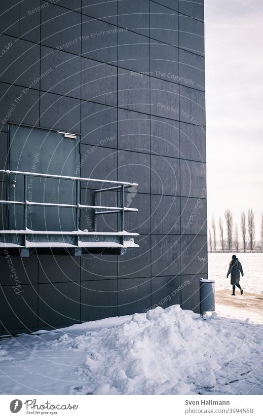 Woman goes around the corner House (Residential Structure) Facade Corner snow surface Walking Day Exterior shot Tracks loner footprints Going Human being