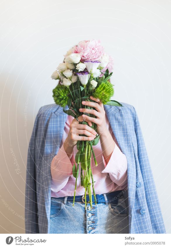 Woman in blue jacket holding pastel peony bouquet woman mother day lifestyle faceless florist mothers day pink flowers spring womens day smile bunch fashion