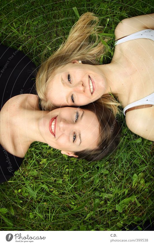 Lia & Kira Feminine Friendship Head 2 Human being Summer Grass Smiling Lie Happiness Joy Together Colour photo Exterior shot Day Looking into the camera