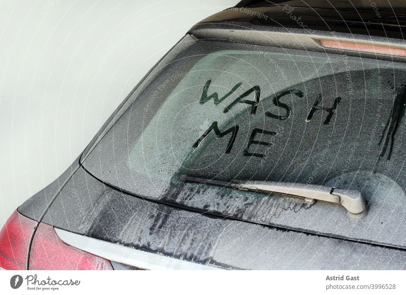 A very dirty car that says wash me Car wash Wash Winter carwash frowzy filth Dirty Salt Snow Rear Window Slice Car window Crust dirt layer purge care polish