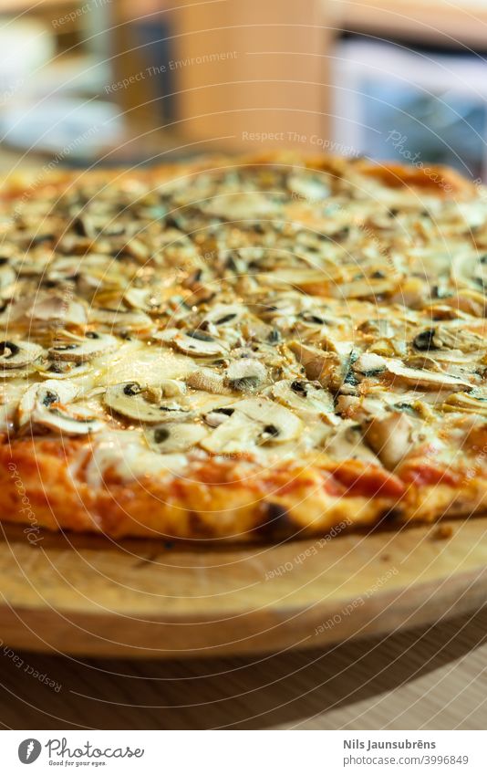 italian pizza with wood plate on bar counter baked cheddar cheese classical closeup cooked crust cuisine delicious dinner dough fast food fresh gourmet greasy
