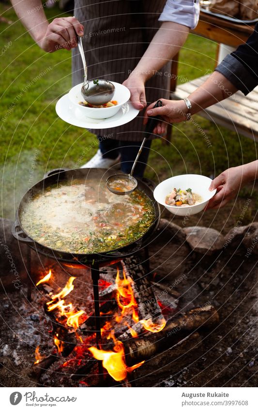Chef making  fish soup on fire in nature Soup plate soup bowl Forest Nature photo Camping Camping site Food photograph food products Food envy warm food