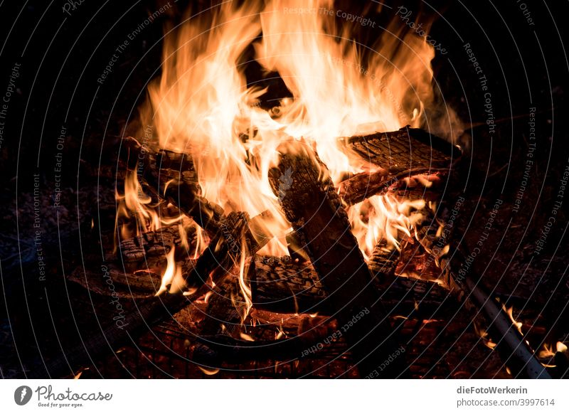 Burning campfire Dark colors Fire Photography Contents Nature Brown Black Night Light Yellow Hot Warmth Orange Fireplace Deserted Embers Wood Incandescent Spark