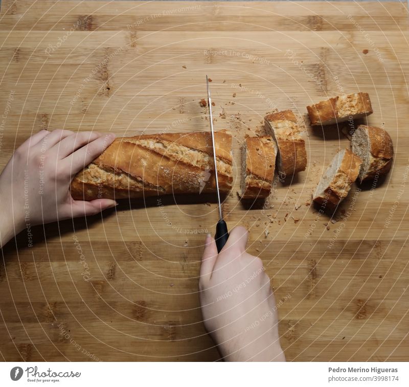 Person cutting bread on a wooden board kitchen cooking table bake knife baker hand eatery traditional delicious food cookery chef wheat making white organic