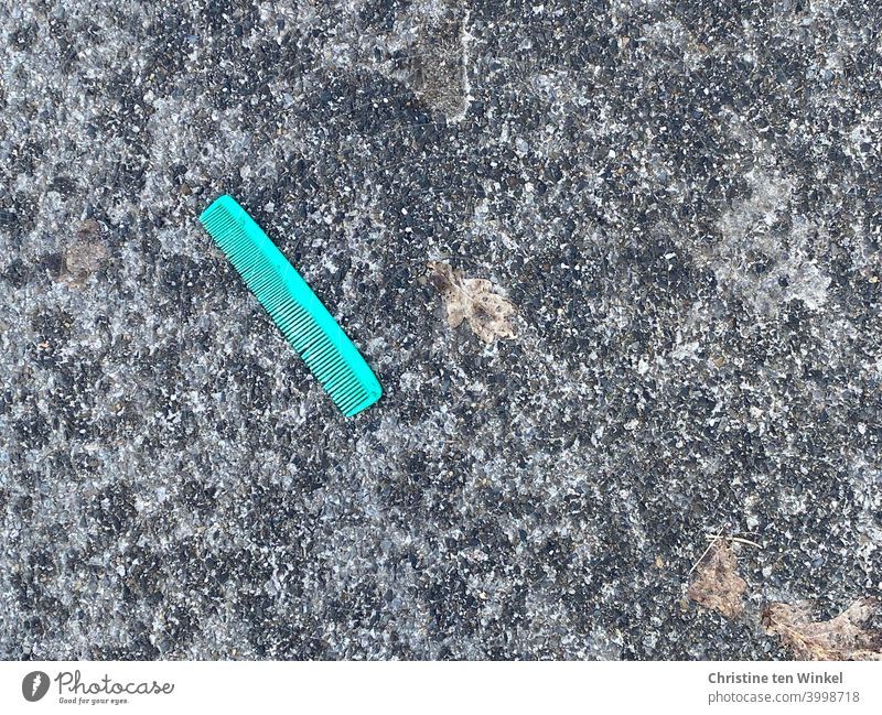 Hairstyle frustration... turquoise lonely comb lies discarded on dark asphalt Comb Throw away Lose jettisoned Doomed Gray Dark Anthracite Turquoise Asphalt