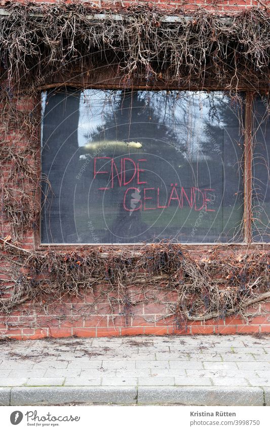 end terrain written on window pane in keyenberg end of ground Window Window pane Labeled writing Text resistance protest action alliance Movement