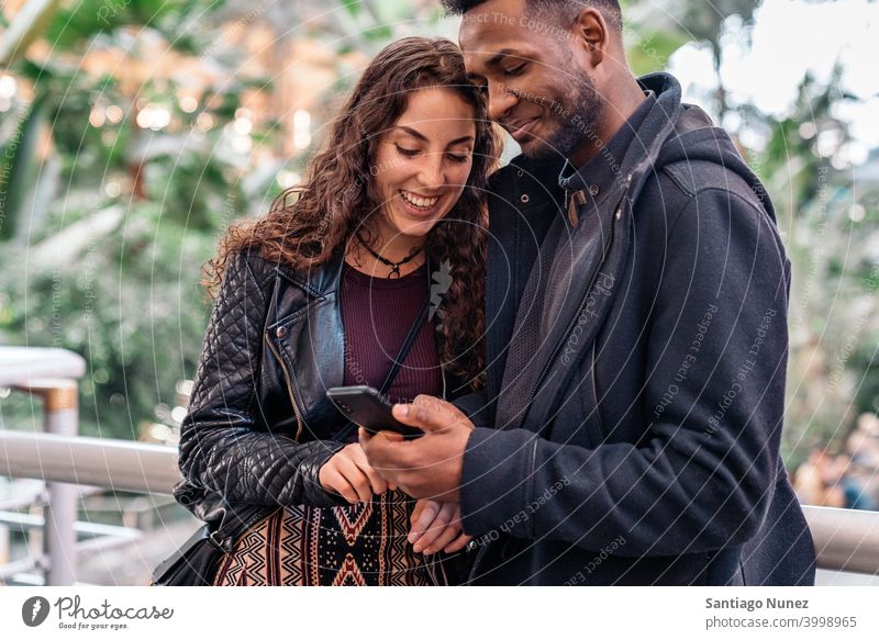 Happy Couple Using Phone couple relationship using phone interracial couple black afro african american cellphone diversity multi-racial black man ethnic