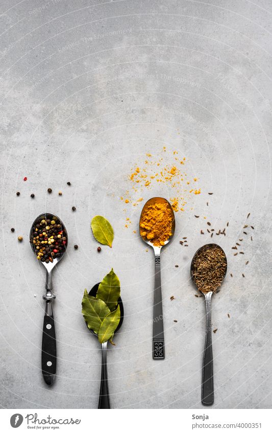 https://www.photocase.com/photos/4000351-variation-of-spices-on-spoons-rustic-background-dot-photocase-stock-photo-large.jpeg