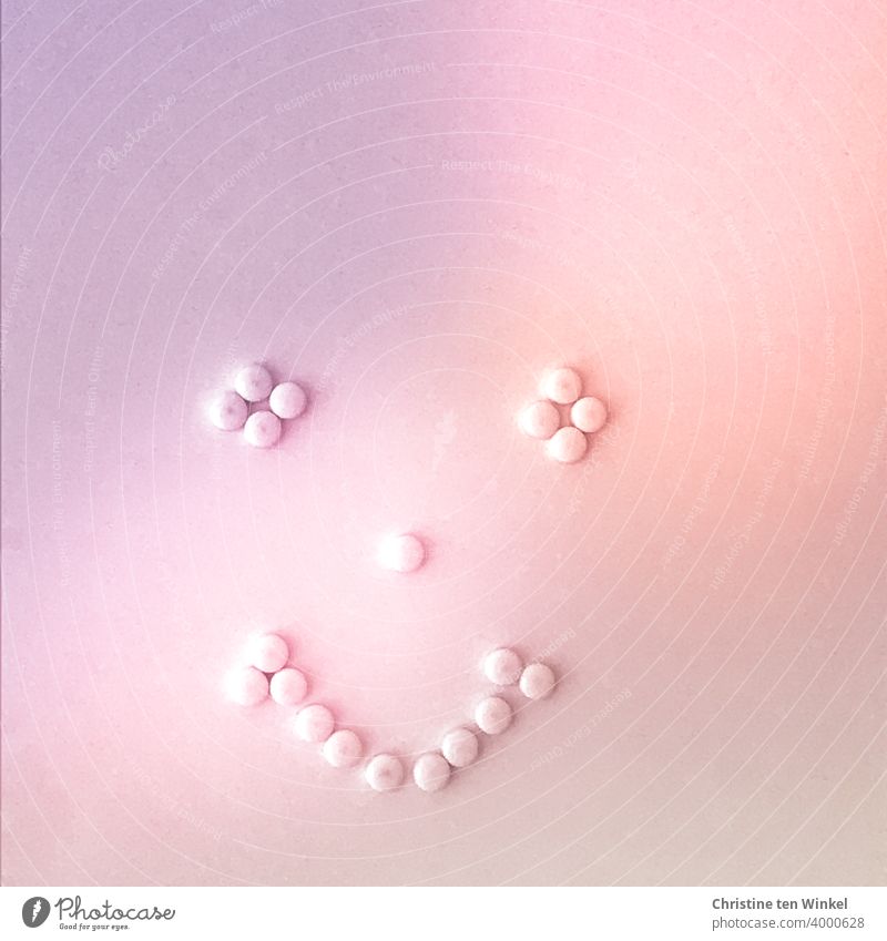 smiling face , designed from small magnets on a magnetic wall, all in shades of pink Face Facial expression Smiling Smiling face stylized kind grinning
