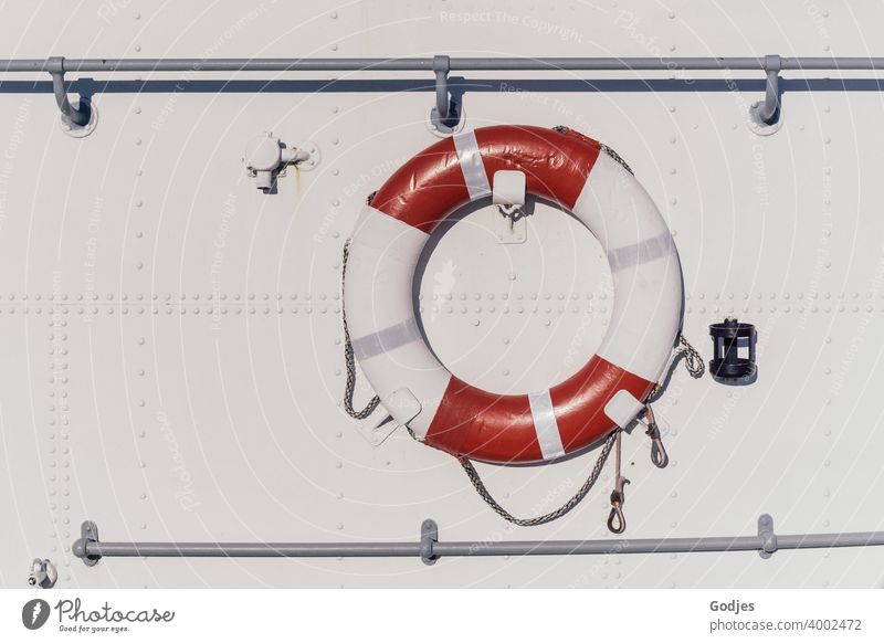 Lifebelt on metal white ship's side Life belt Rescue Navigation Colour photo Exterior shot Deserted Safety Water Ocean Day Watercraft Red Boating trip Blue