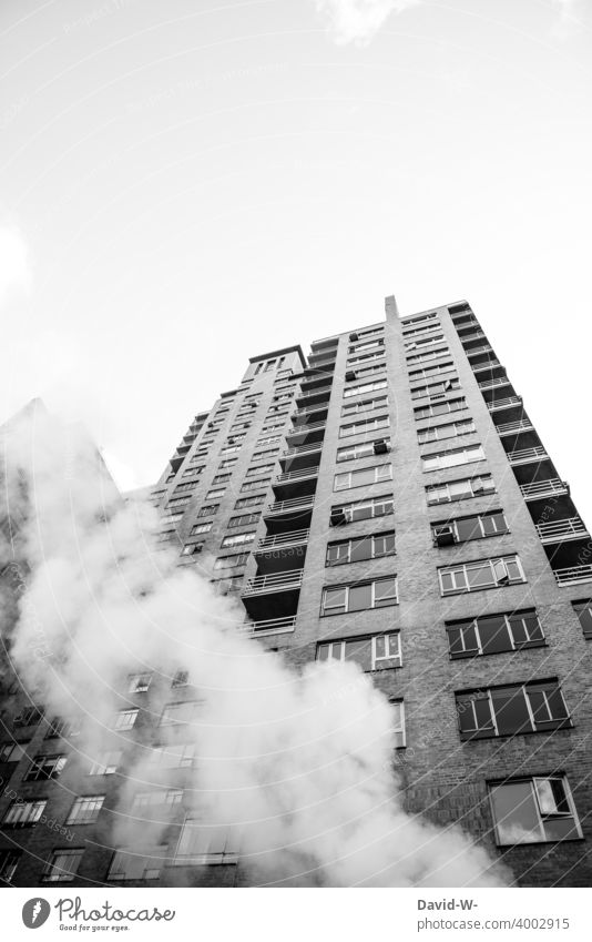 Skyscraper and steam rising into the sky High-rise smoke City New York City USA Blaze Burn Fire Environmental pollution Smog soiling